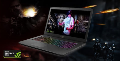 the laptop open, facing to the left, with a screenfill of a young man using a VR headset